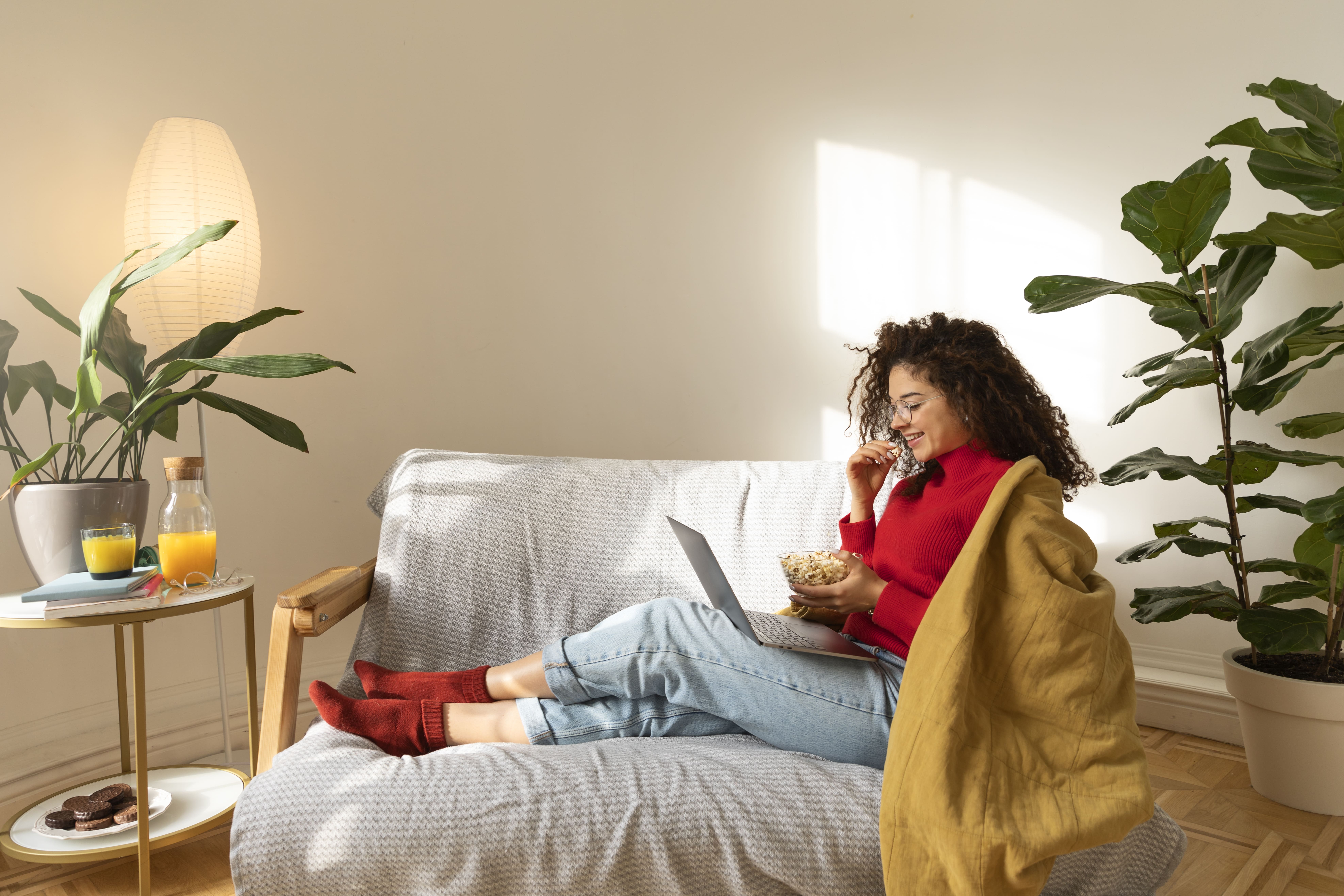 Middle-aged woman relaxing in massage chair at home